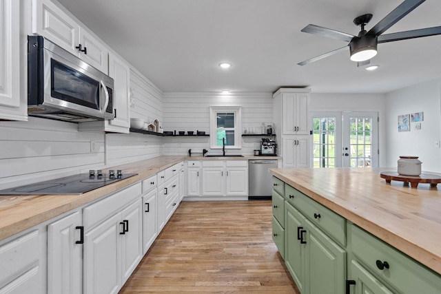 3055 Carters Creek Pike, Franklin, TN 37064 - kitchen with wood counters, appliances with stainless steel finishes, green cabinetry, open shelves, and white cabinets