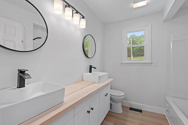 3055 Carters Creek Pike, Franklin, TN 37064 - bathroom with toilet, wood finished floors, baseboards, and double vanity