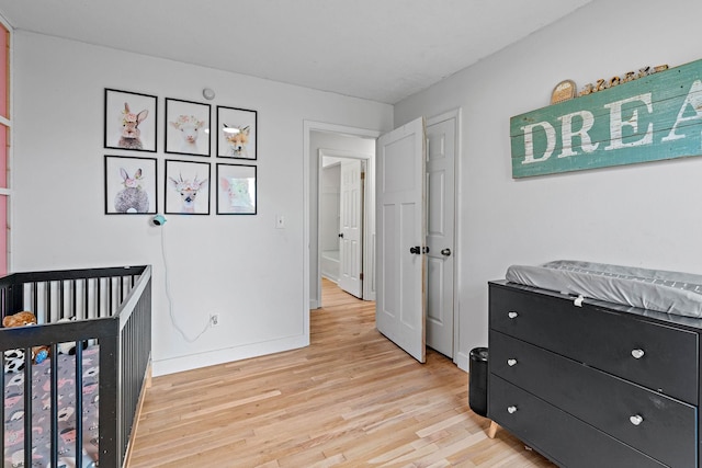 3055 Carters Creek Pike, Franklin, TN 37064 - bedroom featuring light wood-style floors, baseboards, and a nursery area
