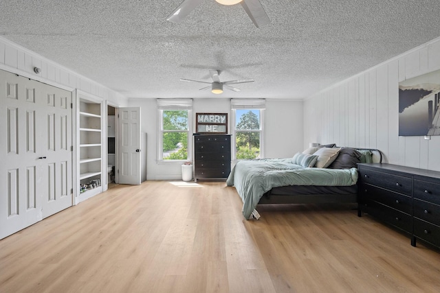 3055 Carters Creek Pike, Franklin, TN 37064 - bedroom featuring wood finished floors, ceiling fan, wood walls, a textured ceiling, and crown molding