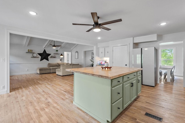 3055 Carters Creek Pike, Franklin, TN 37064 - kitchen with green cabinetry, wooden counters, ceiling fan, freestanding refrigerator, and beam ceiling