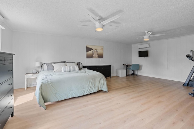 3055 Carters Creek Pike, Franklin, TN 37064 - bedroom featuring a wall unit AC, a textured ceiling, light wood-type flooring, and a ceiling fan