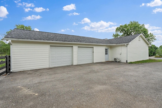 3055 Carters Creek Pike, Franklin, TN 37064 - garage featuring asphalt driveway and fence