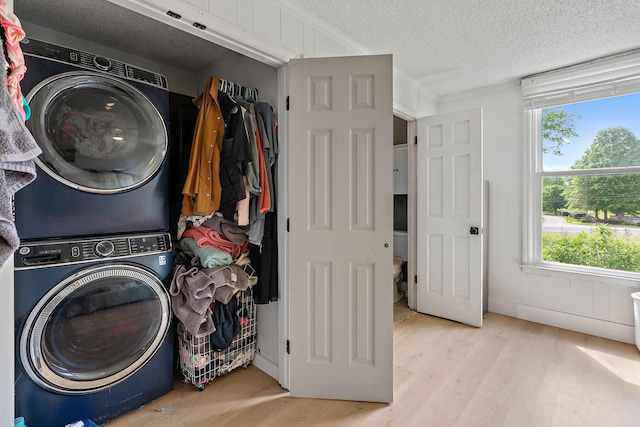 3055 Carters Creek Pike, Franklin, TN 37064 - clothes washing area with stacked washer / dryer, wood finished floors, and a textured ceiling