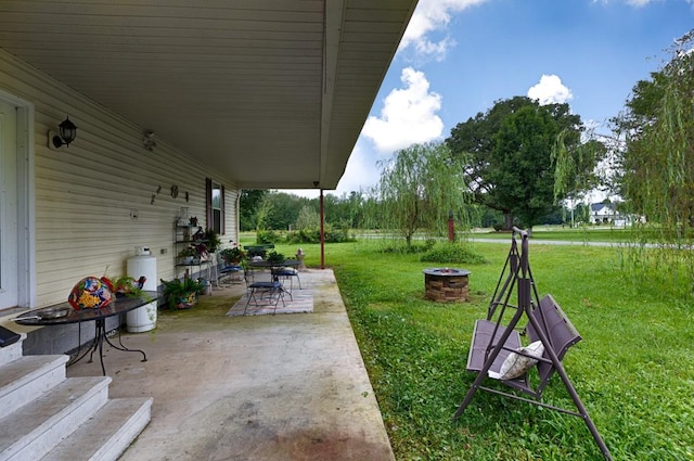 view of patio / terrace with an outdoor fire pit