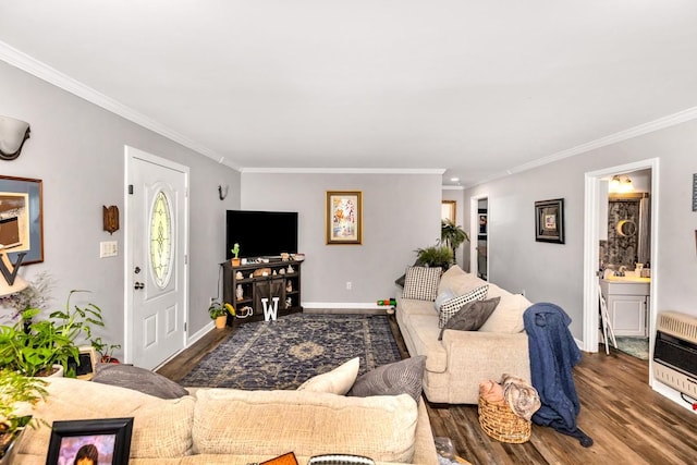 living room with heating unit, wood finished floors, and ornamental molding