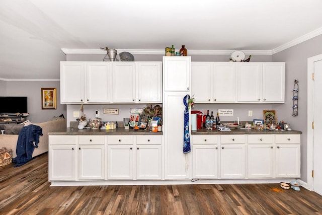kitchen with dark countertops, crown molding, white cabinets, and dark wood-style floors