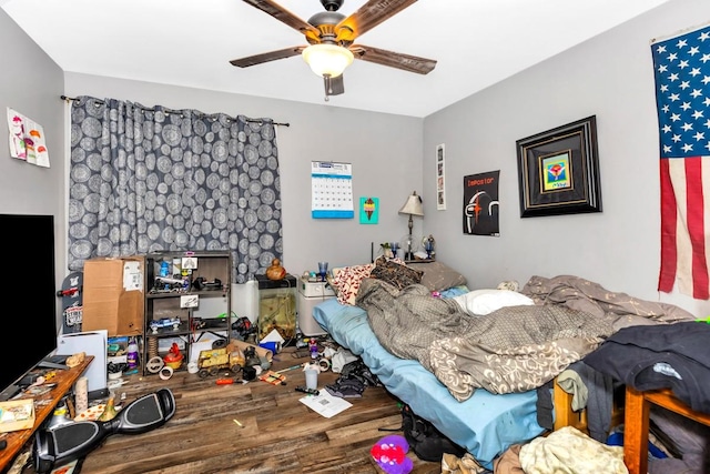 bedroom featuring ceiling fan and wood finished floors