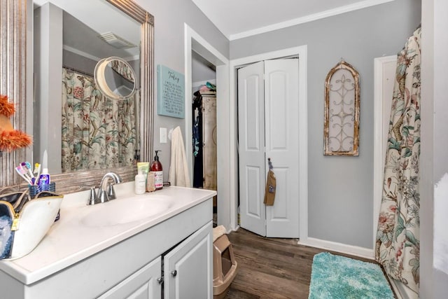 full bathroom with ornamental molding, wood finished floors, and vanity