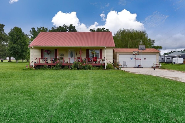 view of front facade with a porch, a front yard, driveway, and metal roof