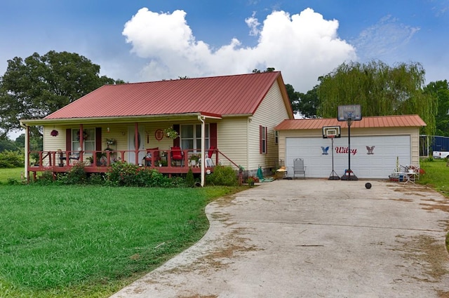 view of front of house featuring a porch, a front lawn, metal roof, and an outbuilding