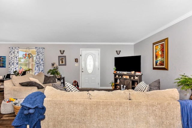 living room with wood finished floors, a healthy amount of sunlight, ornamental molding, and baseboards
