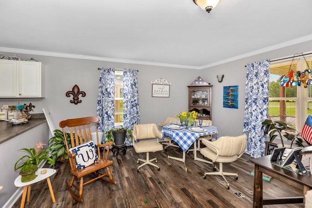 dining room with crown molding, dark wood finished floors, and a healthy amount of sunlight