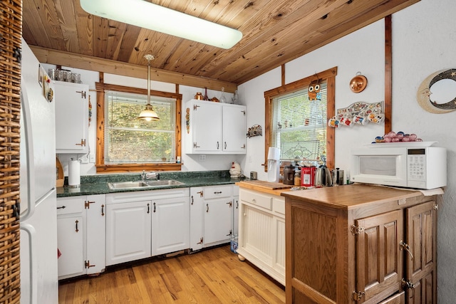 108 Lanham Ln, Monroe, TN 38573 - kitchen with white appliances, light wood-style floors, white cabinets, dark countertops, and a sink