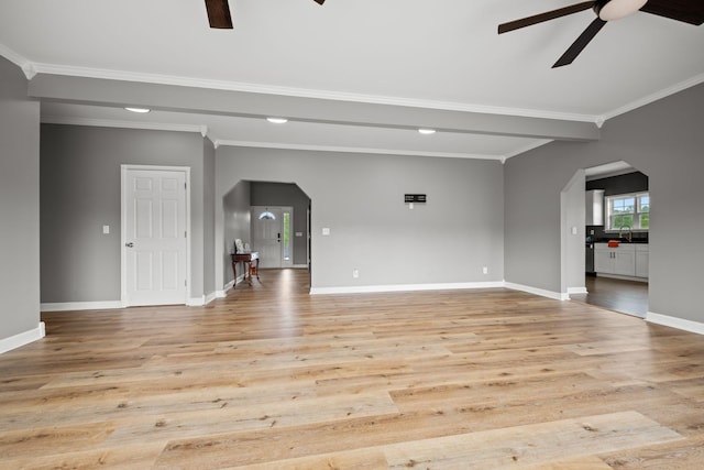 830 Blakemore Rd, Dickson, TN 37055 - unfurnished living room featuring arched walkways, ceiling fan, ornamental molding, and light wood-type flooring