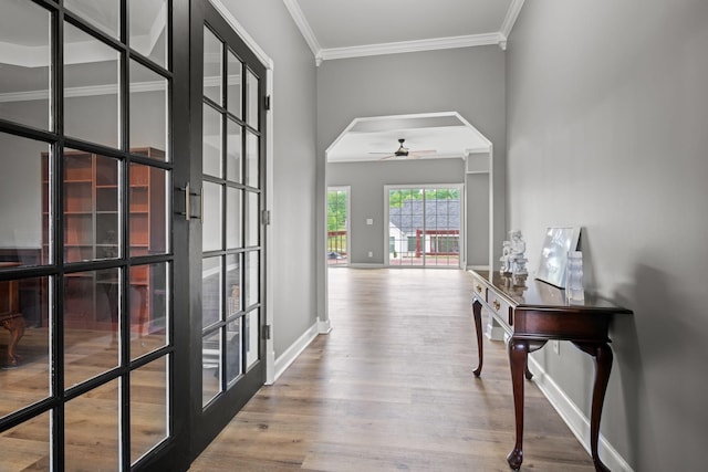 830 Blakemore Rd, Dickson, TN 37055 - hallway with crown molding, arched walkways, baseboards, and wood finished floors