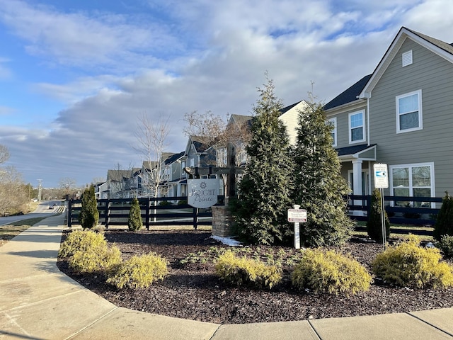 view of side of home featuring fence and a residential view