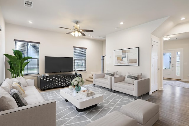 living area featuring a healthy amount of sunlight, visible vents, wood finished floors, and a ceiling fan