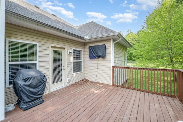 deck with a lawn and area for grilling