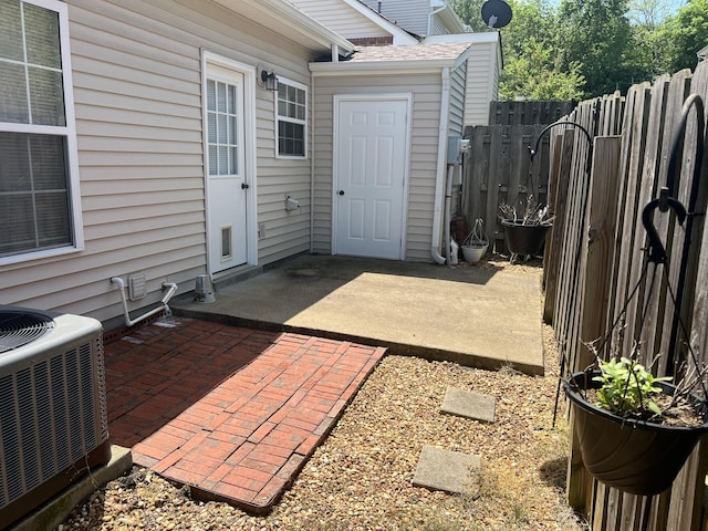 view of patio featuring fence and central air condition unit