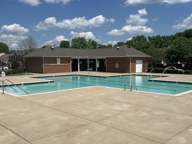 pool featuring a patio and fence