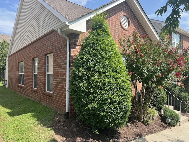 1101 Downs Blvd Unit K101, Franklin, TN 37064 - view of home's exterior featuring brick siding, a yard, and a shingled roof