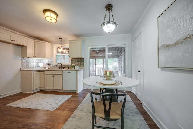 kitchen with light countertops, dishwasher, dark wood-style floors, and a sink