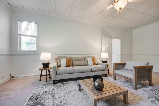 living area featuring a ceiling fan and carpet flooring