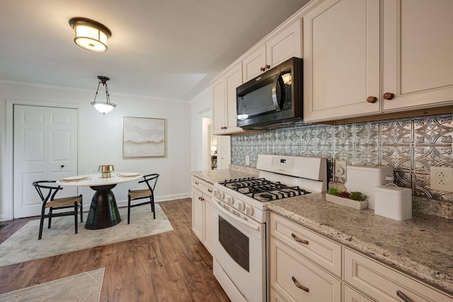 kitchen with light stone counters, decorative backsplash, white range with gas cooktop, ornamental molding, and dark wood finished floors