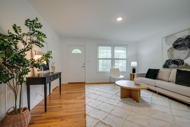 living room featuring light wood-style floors, recessed lighting, and baseboards