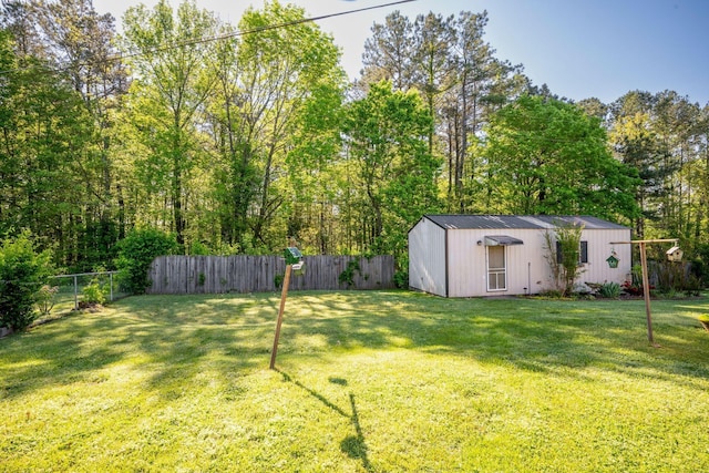 view of yard with an outbuilding and a fenced backyard