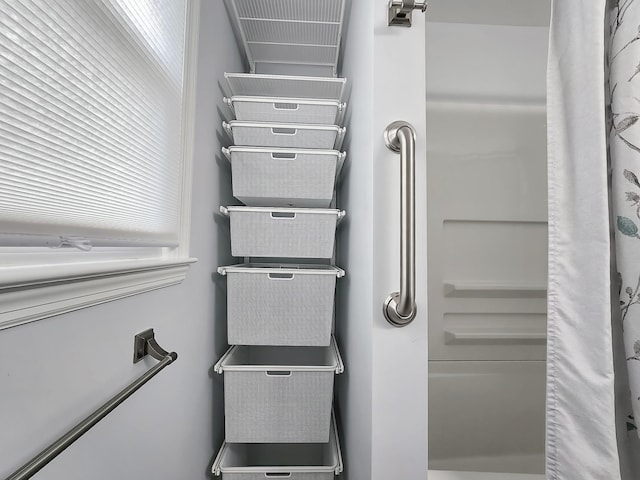 interior space with a shower with shower curtain