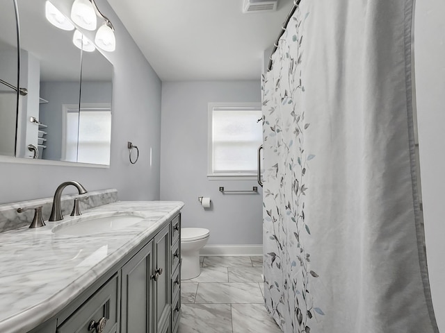 full bathroom with a healthy amount of sunlight, vanity, marble finish floor, and baseboards