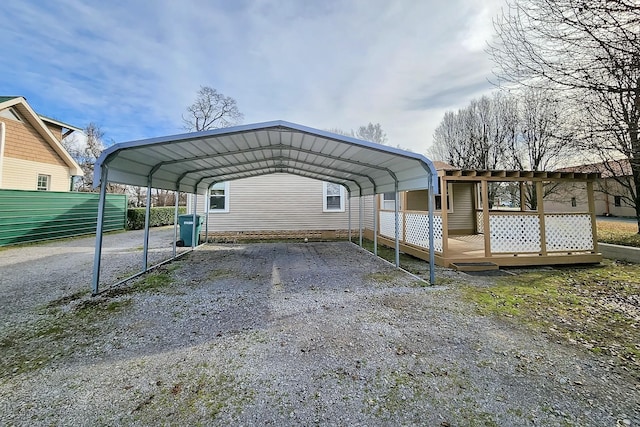 view of parking / parking lot with gravel driveway and a detached carport
