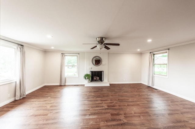 unfurnished living room with crown molding, recessed lighting, ceiling fan, and a wealth of natural light