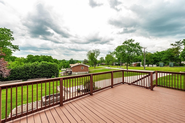 wooden terrace featuring a lawn