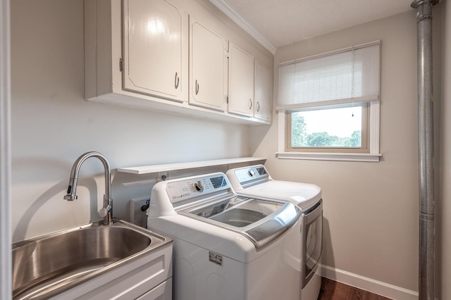 laundry area with independent washer and dryer, cabinet space, a sink, baseboards, and dark wood-style floors