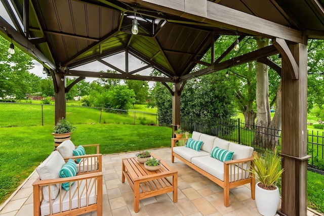 view of patio / terrace with a fenced backyard, a gazebo, and an outdoor living space