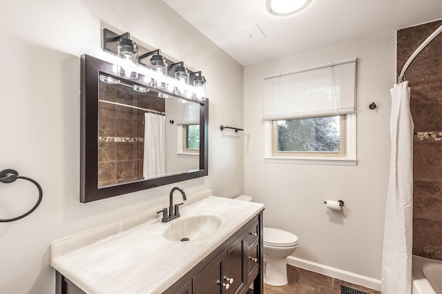 full bath featuring vanity, baseboards, tile patterned floors, and toilet