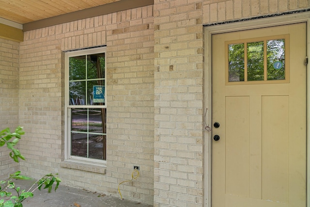 entrance to property with brick siding