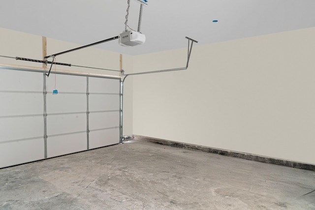 garage with a garage door opener and baseboards