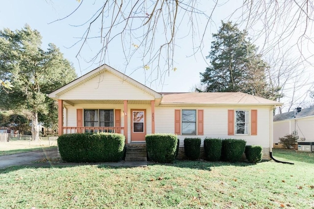 view of front of property with a porch, fence, and a front yard