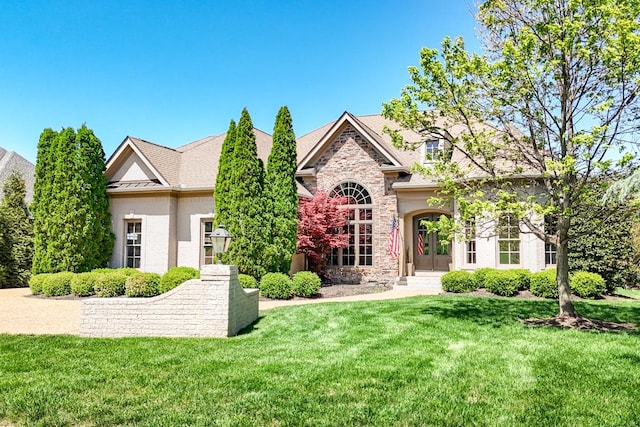 9710 Onyx Ln, Brentwood, TN 37027 - view of front of home featuring french doors, a front yard, and stone siding