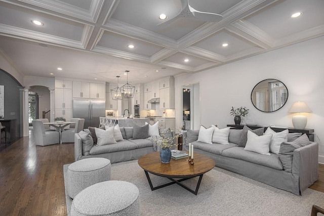 9710 Onyx Ln, Brentwood, TN 37027 - living room with arched walkways, a ceiling fan, decorative columns, and coffered ceiling