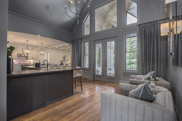 9710 Onyx Ln, Brentwood, TN 37027 - living area featuring an inviting chandelier, ornamental molding, french doors, and wood finished floors
