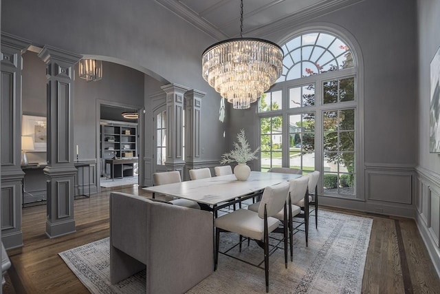 9710 Onyx Ln, Brentwood, TN 37027 - dining room with a decorative wall, arched walkways, a towering ceiling, ornate columns, and dark wood-style floors