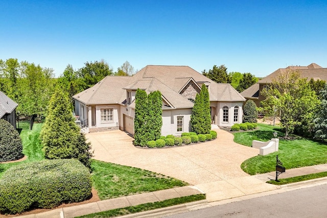 9710 Onyx Ln, Brentwood, TN 37027 - french country home with an attached garage, stucco siding, concrete driveway, and a front lawn