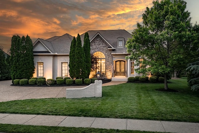 9710 Onyx Ln, Brentwood, TN 37027 - french country home with a lawn, french doors, and stone siding