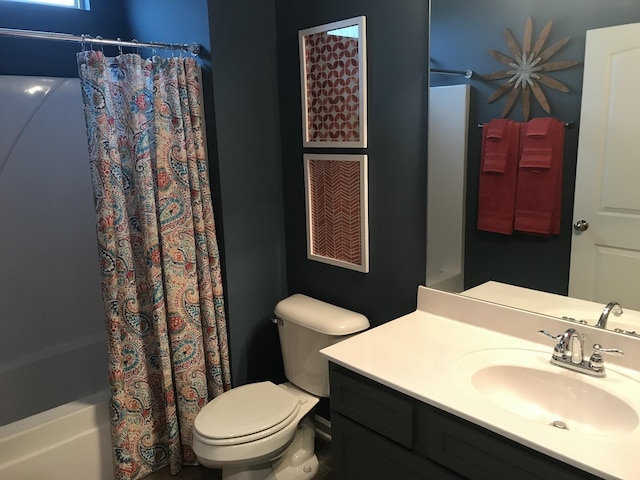 bathroom with shower / bath combination with curtain, toilet, and vanity