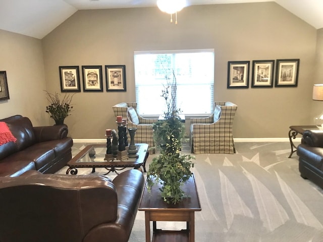living room featuring carpet floors, a ceiling fan, vaulted ceiling, and baseboards